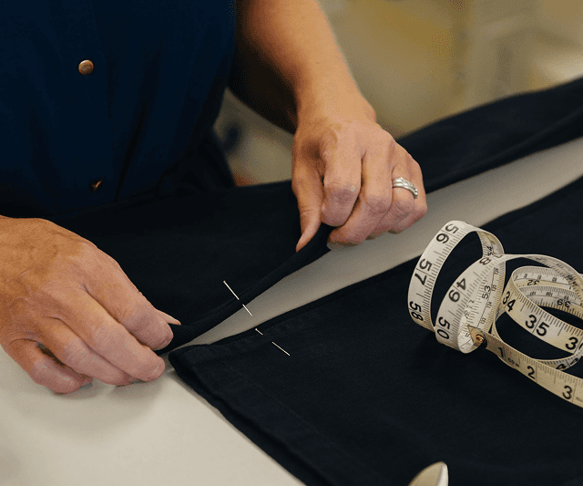 Trousers being modified by tailor
