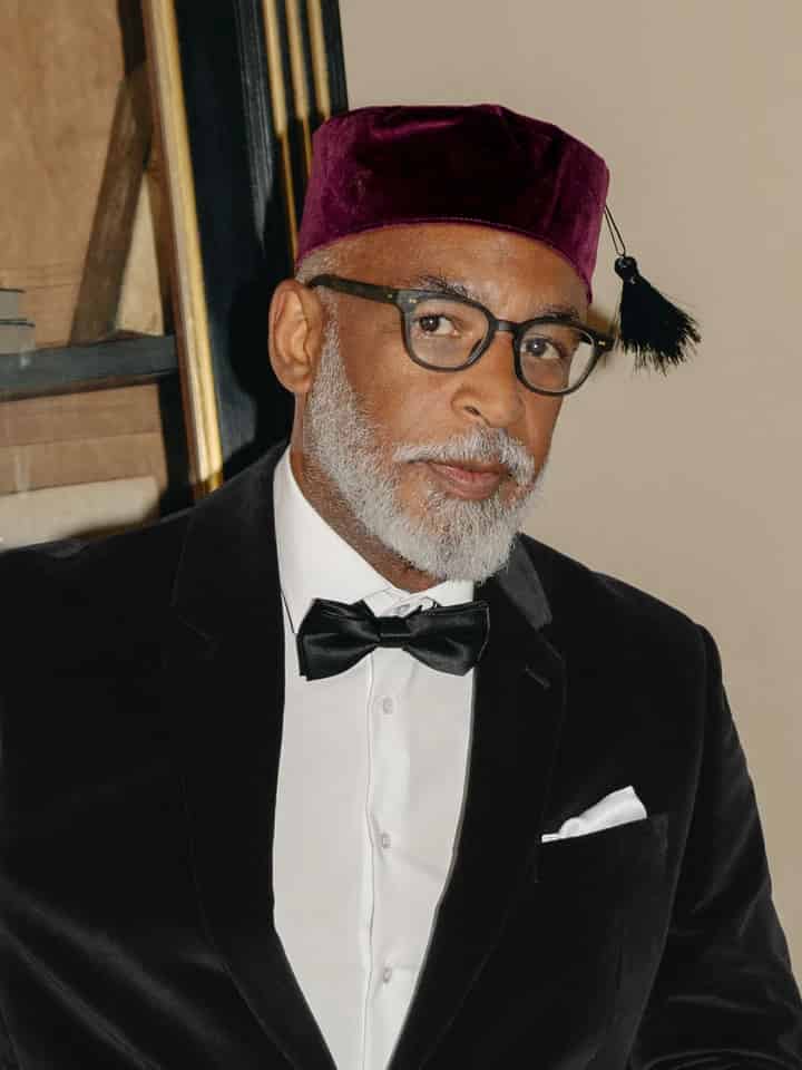 Model wears Men's Burgundy Red Velvet Tasselled Smoking Cap on Model